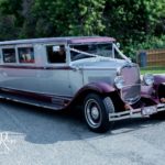 Vintage wedding limousine arriving to pick up guests